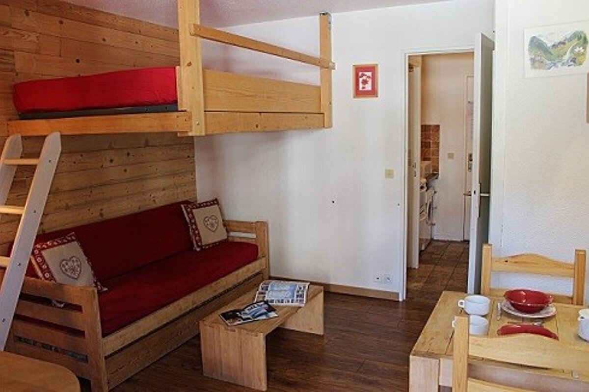 A living room with a couch and a bunk bed