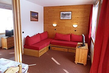 A living room with a couch and a television