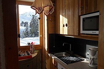 A panasonic microwave sits above a kitchen sink