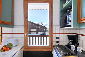 A kitchen with a toaster and a coffee maker