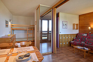 A living room with a bunk bed and a couch