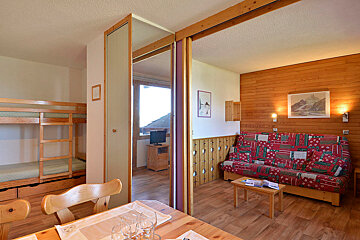 A living room with a couch and bunk beds