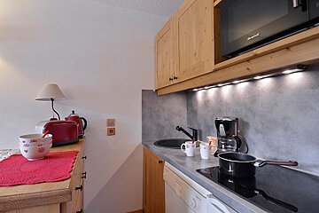 A kitchen with a microwave that says brandt on it