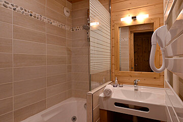 A bathroom with a bathtub and a sink
