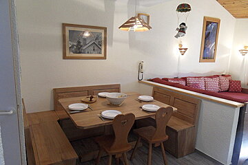A wooden table with plates and a bowl on it
