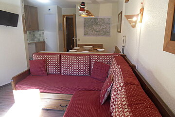 A living room with a couch and a map on the wall