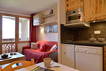 A living room with a couch and a dishwasher