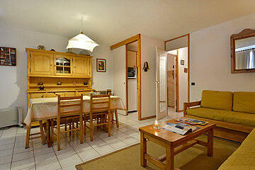 A living room with a table and chairs and a couch
