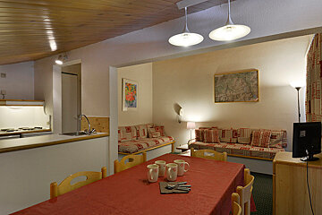 A living room with a table and chairs and a couch