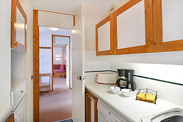 A kitchen with a coffee maker and a toaster oven