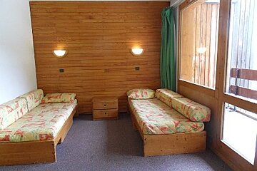 A living room with two couches and a window