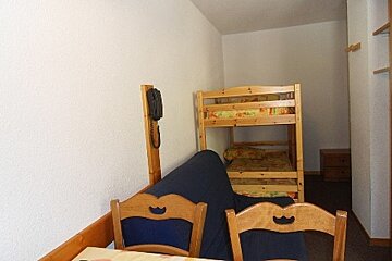 A room with a bunk bed and a couch