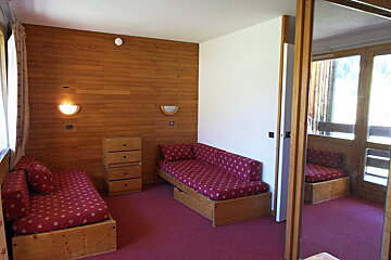 A living room with a couch and a mirror