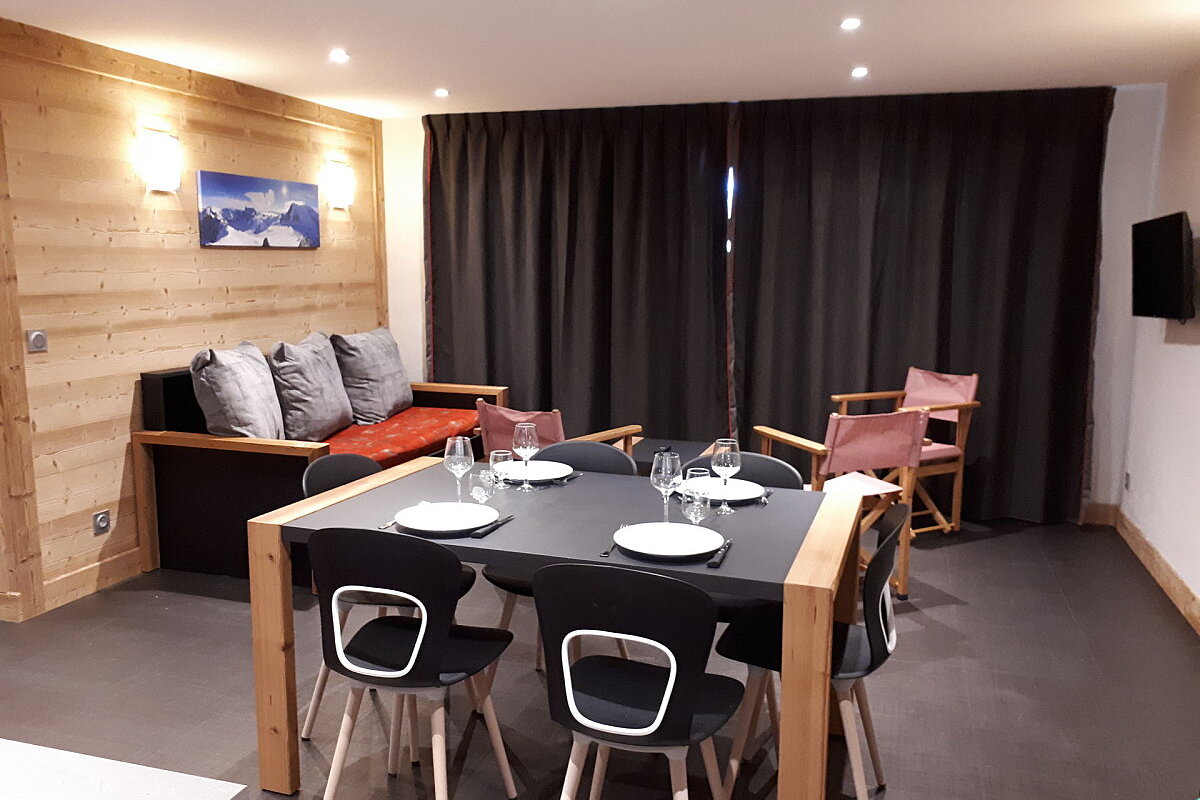 A living room with a dining table and chairs