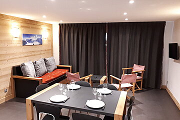 A table with plates and glasses on it in a living room