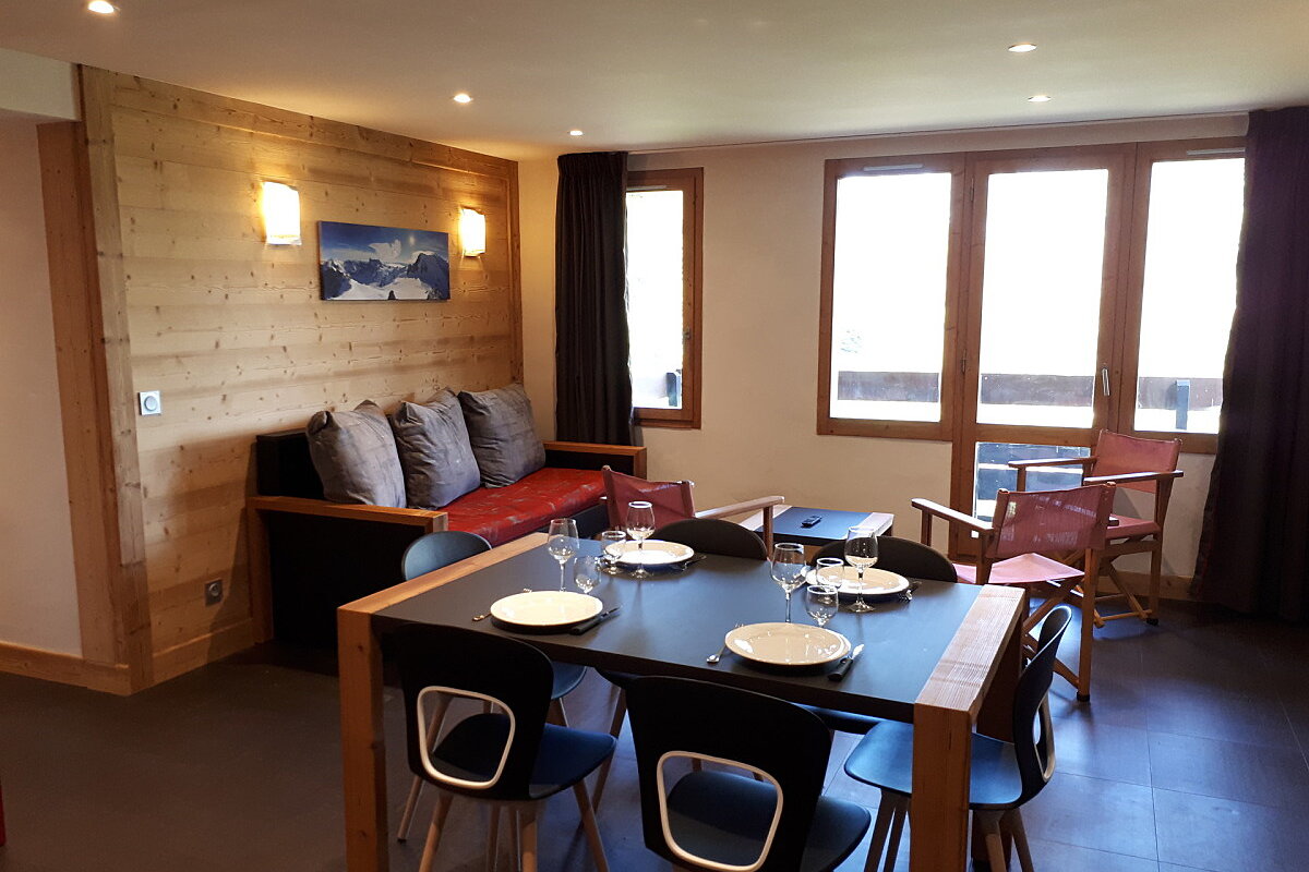 A living room with a dining table and chairs