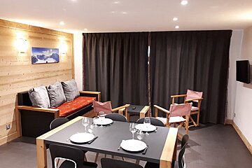 A table with plates and glasses on it in a living room
