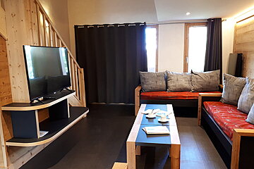 A living room with a couch and a flat screen tv