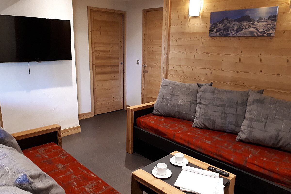 A living room with a couch and a flat screen tv