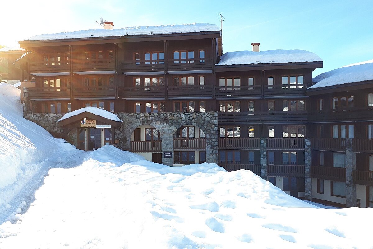 A snowy building with a sign that says ' altitude ' on it