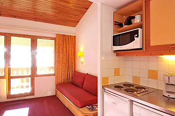A kitchen with a microwave above the stove