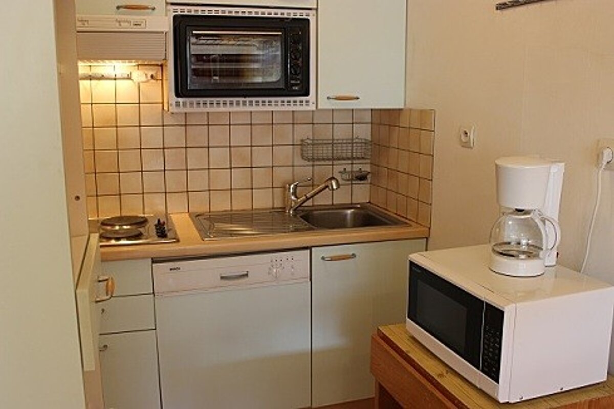 A small kitchen with a microwave and a coffee maker