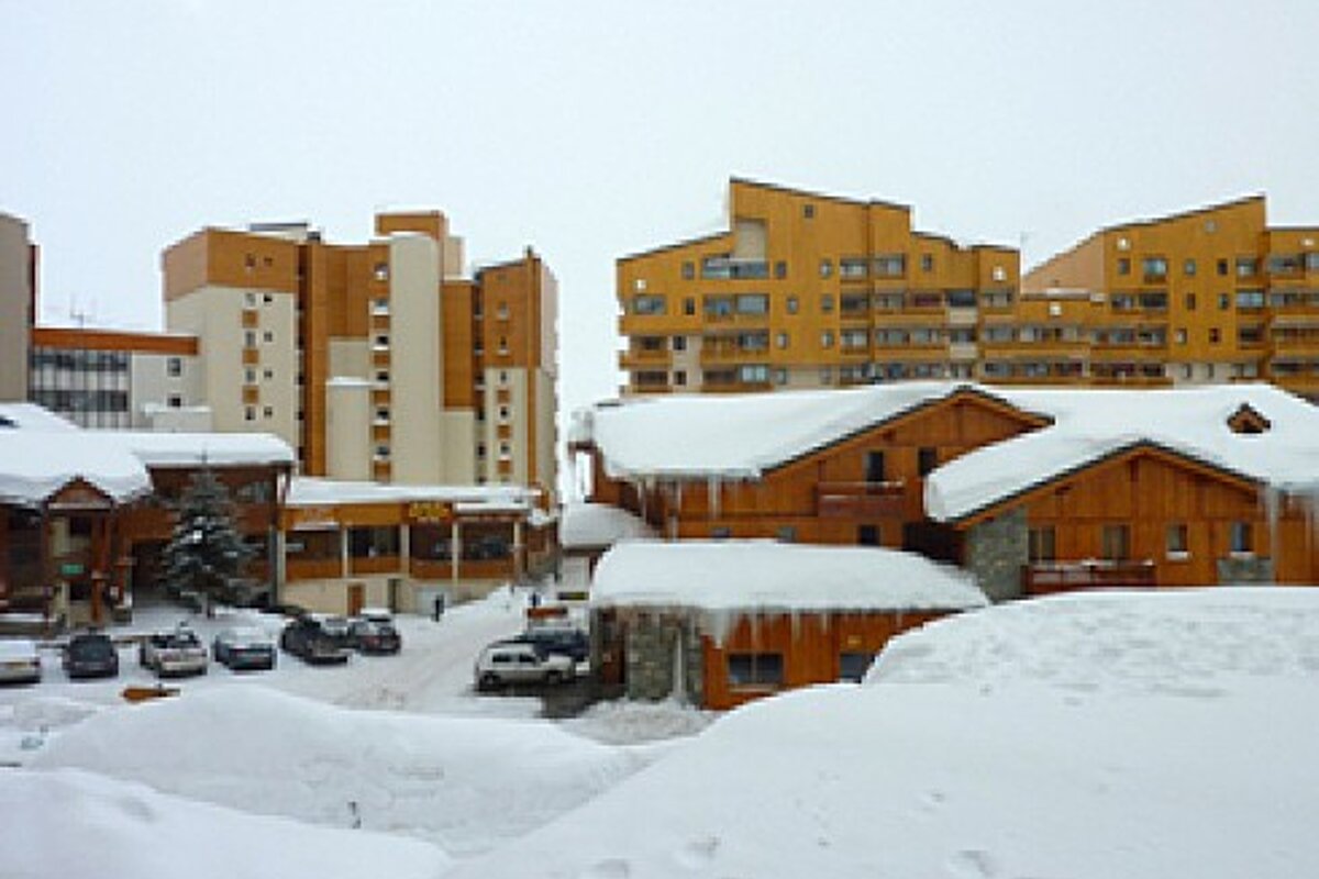 A snowy area with a lot of buildings covered in snow