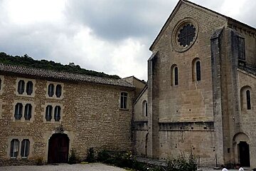a photo of a stone building and the back of a church