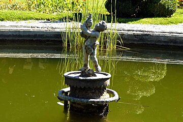 image of a boy statue in a pond