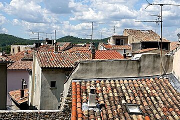 photo of tiled rooftops and green hills