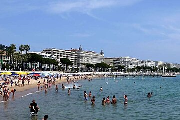 photo of the sea and a beach and a city