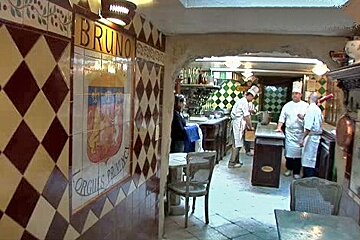 Tiled corridor opening onto kitchen counter and cooks