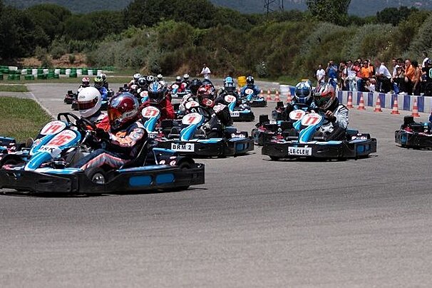 many karts in a race on outdoor track