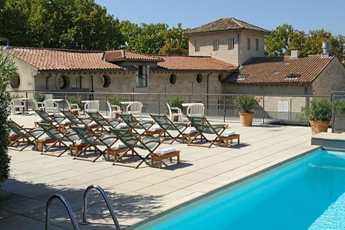 A large swimming pool with a lot of chairs around it