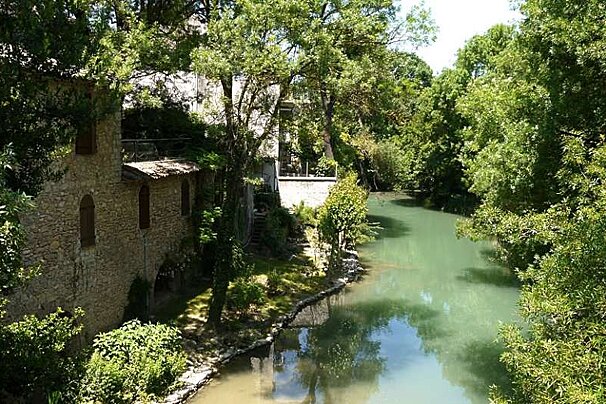 an image of a river and stone buildings