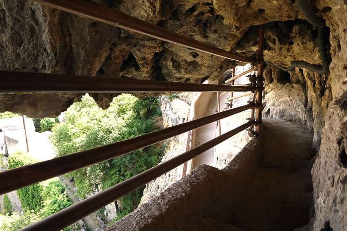 an image of a walkway within a rock face