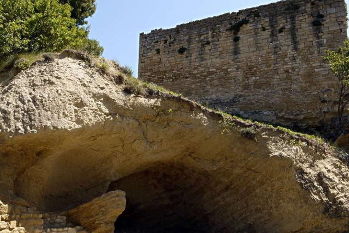an image of a cave and a ruined castle