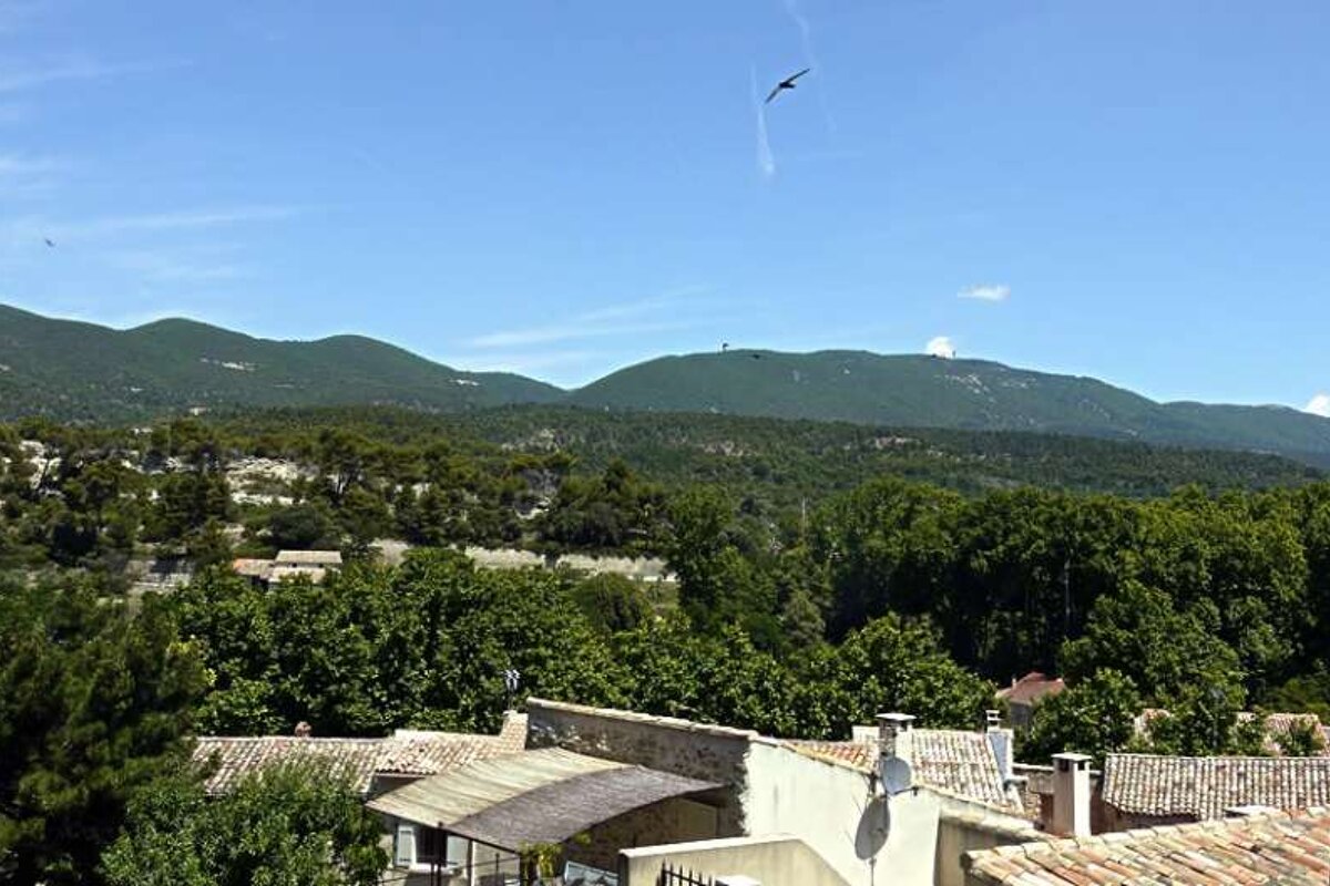 an image of a village and the green hilly countryside