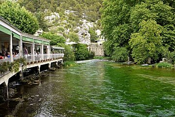 a photo of a cafe by a river