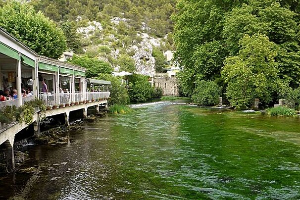 a photo of a cafe by a river