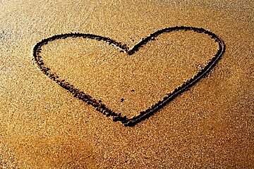 photo of heart in sand
