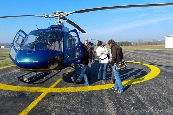 helicopter on tarmack with embarking passengers