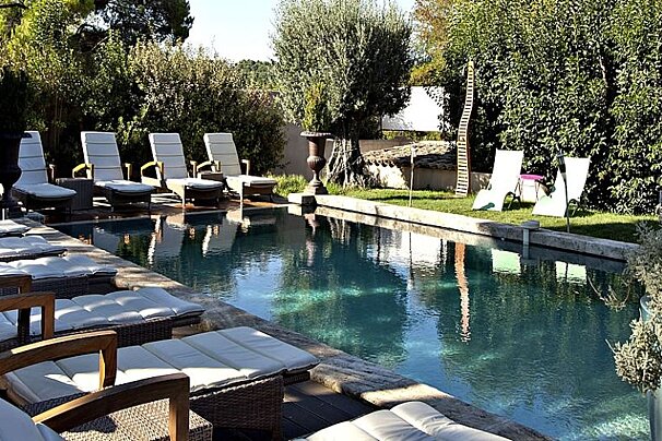 photo of a swimming pool and sun loungers