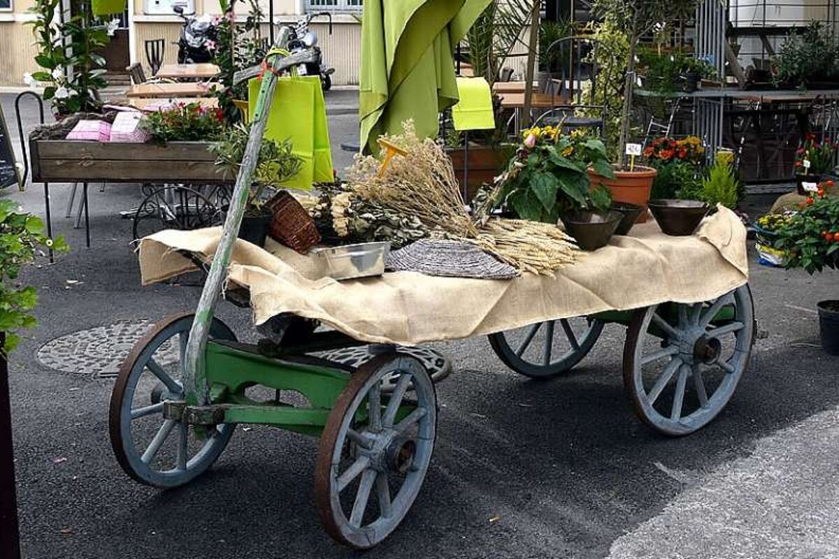 a photo of a four wheeled wheelbarrow