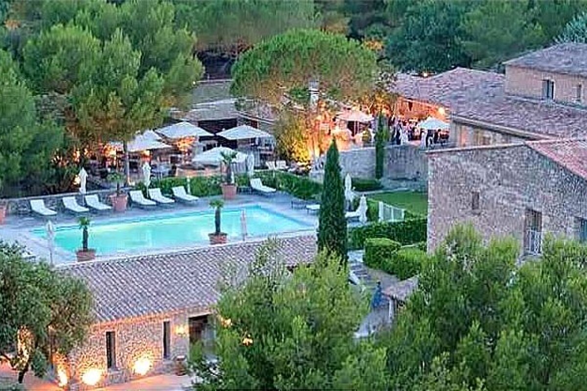 photo of a swimming pool and a stone house