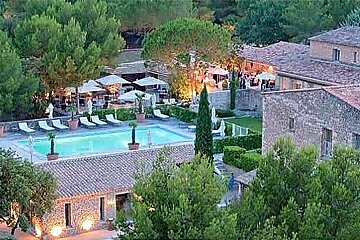photo of a swimming pool and a stone house