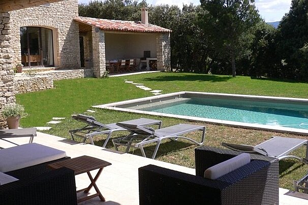 photo of a swimming pool and a house