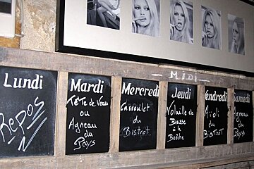 photo of blackboards on a stone wall