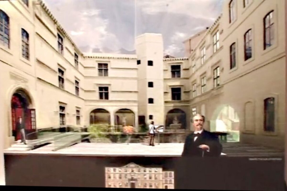 scale model of large old building inner courtyard with 3 figures
