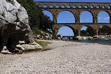a photo of a beach and a bridge